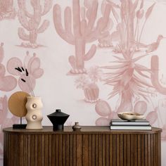 a table with two vases on top of it and a wall paper behind it