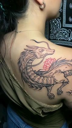 a woman with a dragon tattoo on her back