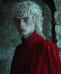 a man with white hair and blue eyes wearing a red shirt in front of a stone wall