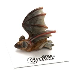 a small figurine of a bat flying through the air