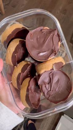 a plastic container filled with chocolate covered cookies