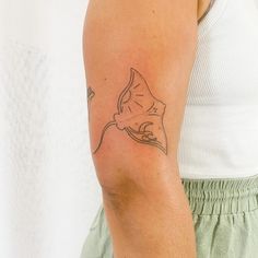 a woman with a tattoo on her arm