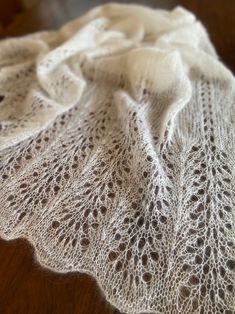 a white lace doily sitting on top of a wooden table