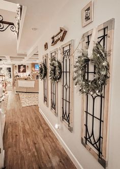 the hallway is decorated for christmas with wreaths on the wall and decorations hanging from the ceiling