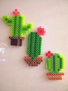 three pieces of plastic beaded cactus with flowers