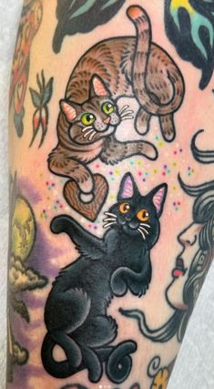 an arm with some cats on it and one cat is jumping up in the air