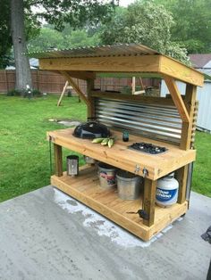 an outdoor bbq with grill and sink built into it