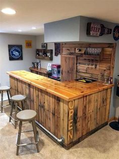 a bar made out of pallet wood with stools