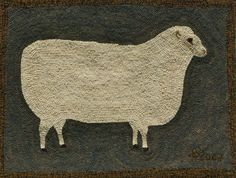 a white sheep standing on top of a brown ground next to a black and tan rug