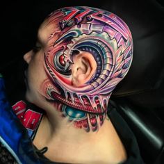 a man with tattoos on his face and neck