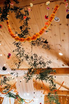 the ceiling is decorated with flowers and greenery