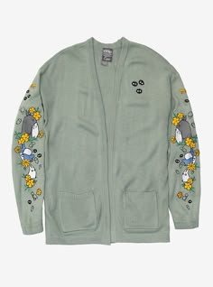 a green cardigan jacket with cartoon characters on the sleeves and an embellishment