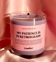 a candle that is sitting on top of a pink cloth with the words, my patience is in front of it