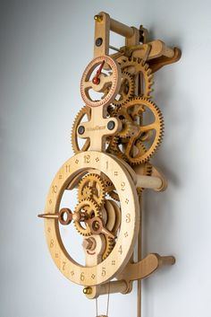 a wooden clock with gears attached to it