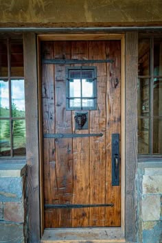 an old wooden door in front of a stone building