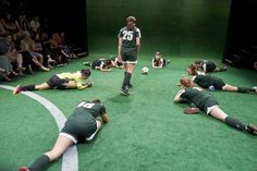 a group of people laying on top of a soccer field