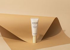 a tube of cream sitting on top of a piece of paper next to an envelope