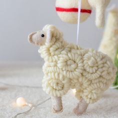 a white sheep ornament hanging from a string