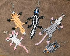 four beaded key chains with different designs on them