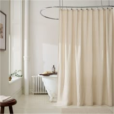 a bath room with a tub and a shower curtain