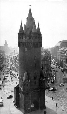 an old black and white photo of a large tower with a clock on it's side