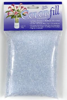 a package of blue glitter flakes with flowers in the center and on it's side