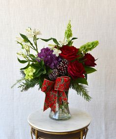 a vase filled with flowers on top of a table