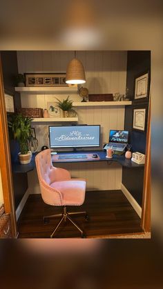 an office with a desk, chair and computer monitor on it's standup