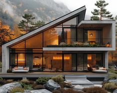 a modern house in the mountains surrounded by rocks