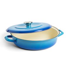 a blue casserole dish with a lid and handle on the side, sitting in front of a white background