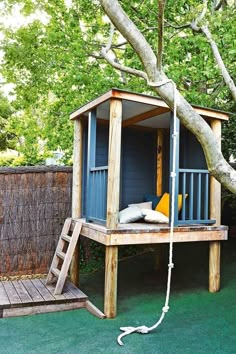 a tree house with a ladder to the roof