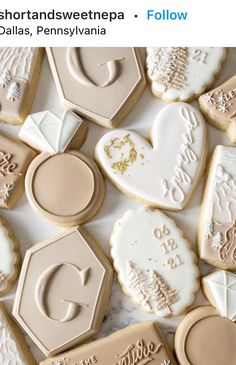 some cookies that are on top of a white tablecloth and one is decorated with icing