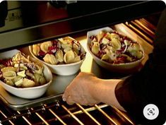 three bowls of food are being cooked in the oven with one person pulling them out