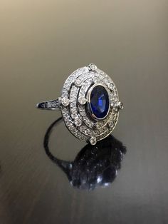 DeKara Designs CollectionArt Deco Inspired Extremely Elegant Halo Sapphire Diamond Engagement Ring.Metal- 90% Platinum, 10% Iridium.Stones- 1 Oval Ceylon Blue Sapphire 1.25 Carats, 100 Round Diamonds F-G Color VS2 Clarity .80 Carats.  Size- 6 1/4.An Amazing Art Deco Inspired Ceylon Blue Sapphire Triple Halo Diamond Engagement.  The ring features a beautiful Ceylon Blue Sapphire that is expertly bezel set in the center.  The sapphire is surrounded by 92 pave and burnish set round sparkling diamon Platinum Sapphire Ring, Sapphire Diamond Engagement Ring, Diamond Sapphire Engagement Ring, Sapphire Diamond Engagement, Platinum Wedding Rings, Platinum Diamond Rings, Wedding Rings Halo, Engagement Rings Platinum, Diamond Wedding Ring