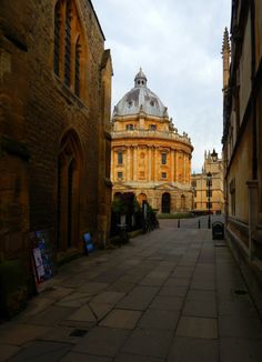 an old building with a dome in the middle of it's alley way next to other buildings