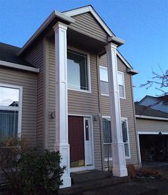 a brown house with white trim and windows