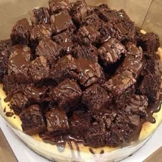 there is a large plate of brownies with chocolate on the top and drizzled in sauce