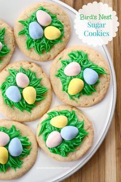 cookies decorated with grass and eggs on a plate