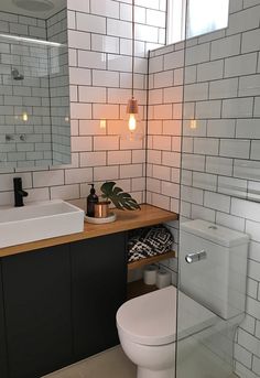 a white toilet sitting next to a bathroom sink