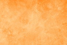 an orange background with some stains on it