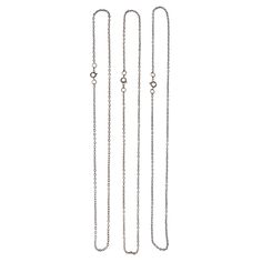 three long chain necklaces on a white background