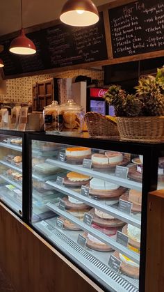 a display case in a bakery filled with cakes and pies