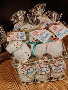 a basket filled with marshmallows on top of a wooden table and wrapped in foil