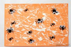 an orange paper with black and white eyes on it