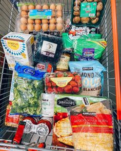 a shopping cart filled with groceries and food