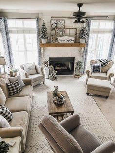 a living room with couches, chairs and a fire place in the middle of it