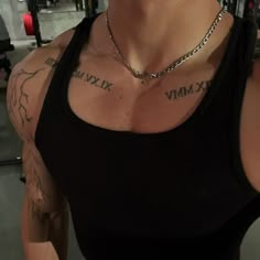 a woman with tattoos on her chest in a gym