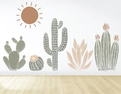 a room with cactus and sun decals on the wall, along with wooden floors