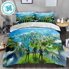 a bed with two people standing in front of a scenic scene on the cover and pillow