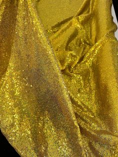 the fabric is shiny and gold in color